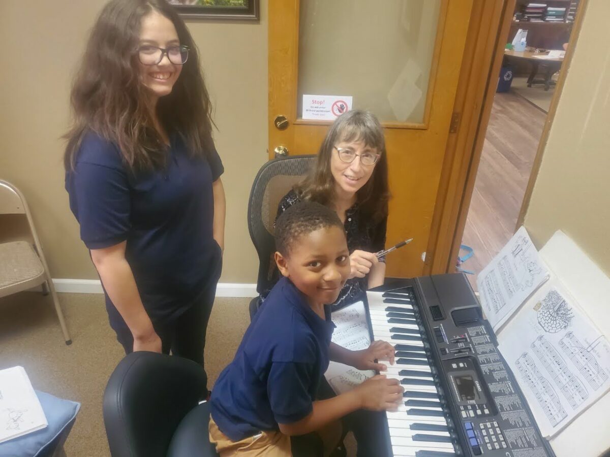 student being instructed on piano